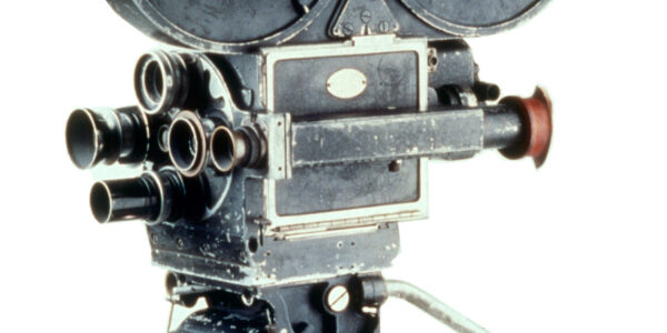 Camera closeup, including body and top of tripod