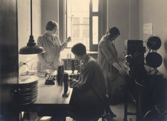 Edna Rollins, Mildred Califano, and Helene Turner in an editing room at the Astoria Studio in the early 1930s. The building that now houses Museum of the Moving Image is visible through the window.