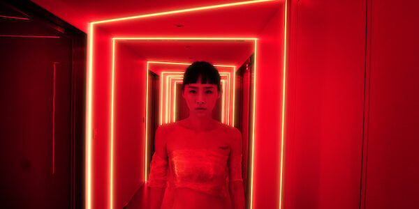 Woman in neon red hallway