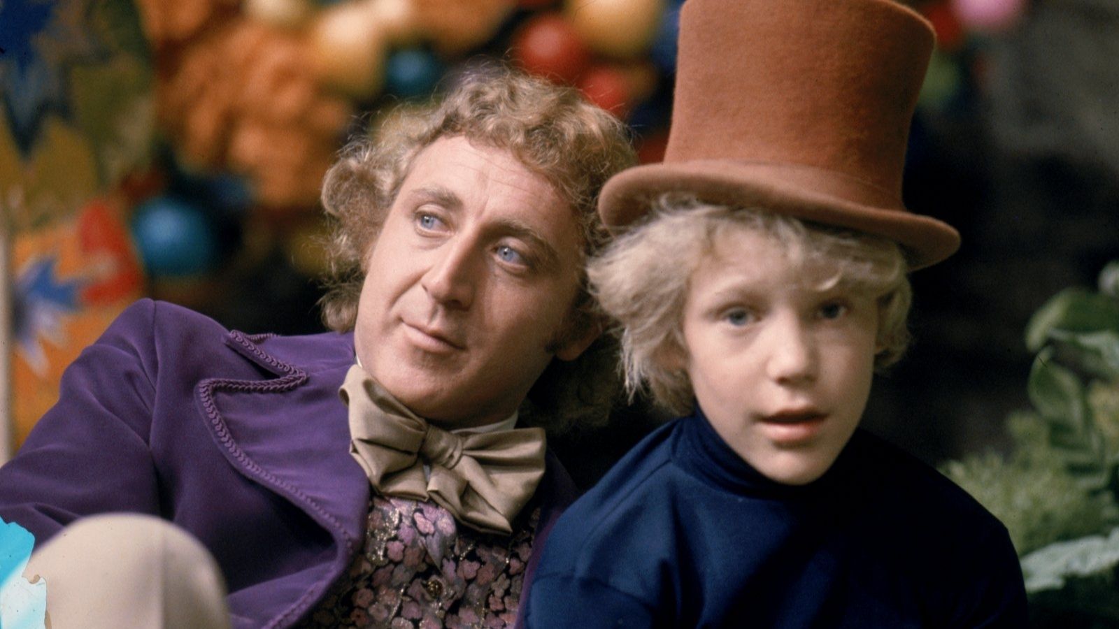 Willy Wonka on the left and Charlie Bucket on the right in a top hat