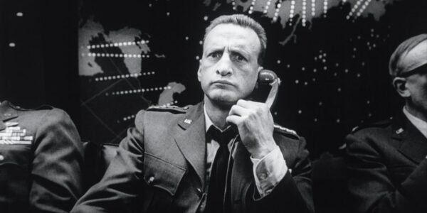George C. Scott looking confused as he holds a phone