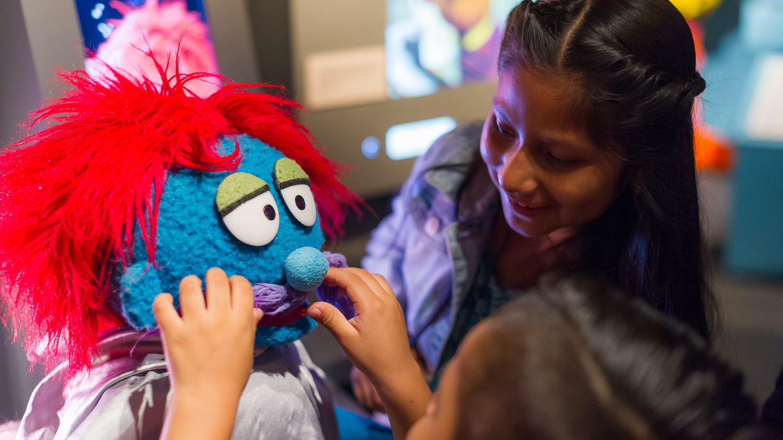 A kid designs a muppet at the interactive "Anything Muppet" station in The Jim Henson Exhibition at Museum of the Moving Image.