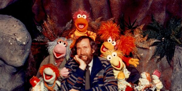 Jim Henson surrounded by his Fraggle puppet creations, all looking at the camera.