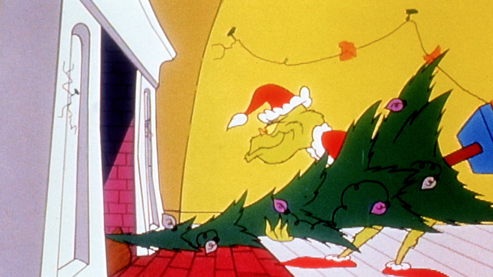 The animated character the Grinch, in a Santa Hat, tries to stuff a tree up a chimney.