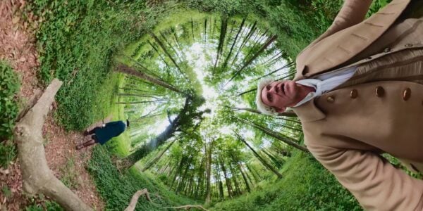 A fantasy spiral effect of an outdoor scene of two men in a green forest