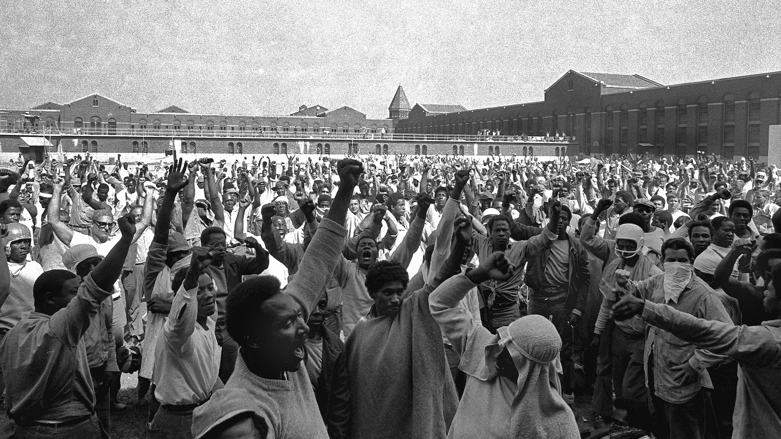 This Sept. 10, 1971 file photo shows inmates of Attica State Prison as they raise their hands in clenched fist salutes to voice their demands during a negotiating session with New York's prison Commissioner Russell Oswald. The whistleblower who spurred a major state investigation of alleged crimes and cover-ups at Attica prison is still on the case four decades later. Ex-prosecutor Malcolm Bell, now 82 and retired to the Green Mountains of Vermont, recently filed court papers in support of opening long-sealed investigation volumes.