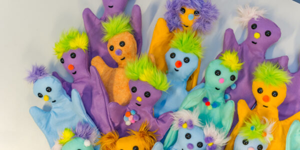 Brightly colored puppets in a pile