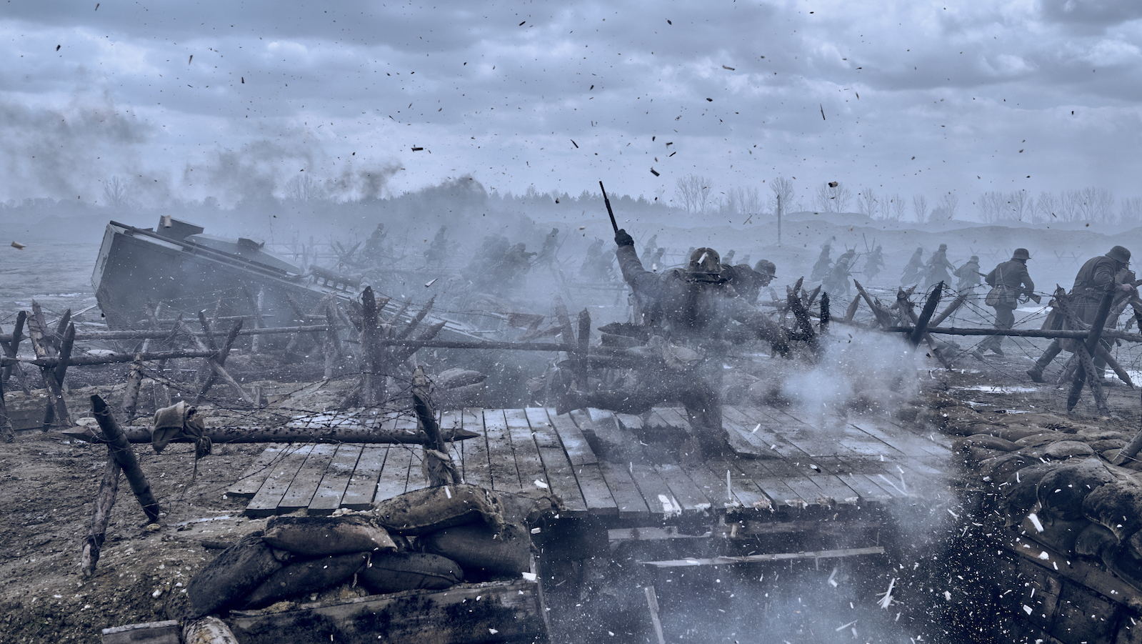 Soldiers fighting on a bridge as it's being decimated by bullets and shrapnel