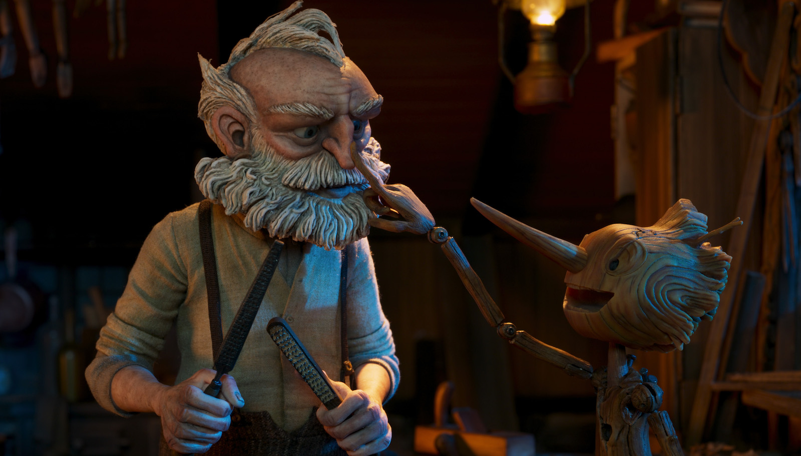 The smiling puppet Pinocchio touches the nose of his father Gepetto
