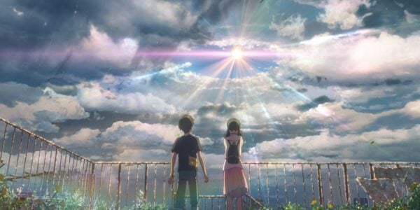 Two teenagers stand in a field and look up at a bright light breaking through clouds.
