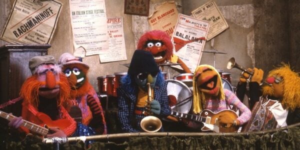 A muppet rock band play instruments—drums, guitars, horns.