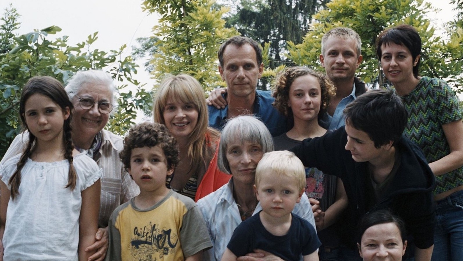 A large family looks into the camera, posing for a photo