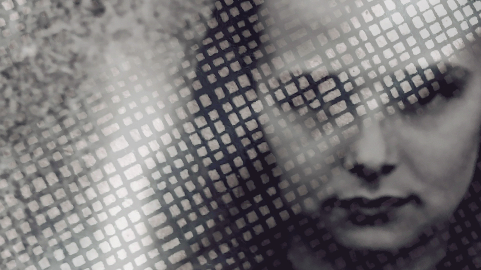 A black and white photo of a girl's face looking at camera, covered partly by a white grid of rectangles