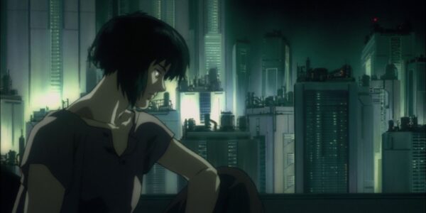 an animated image of a woman sitting in profile against a gloomy grey cityscape