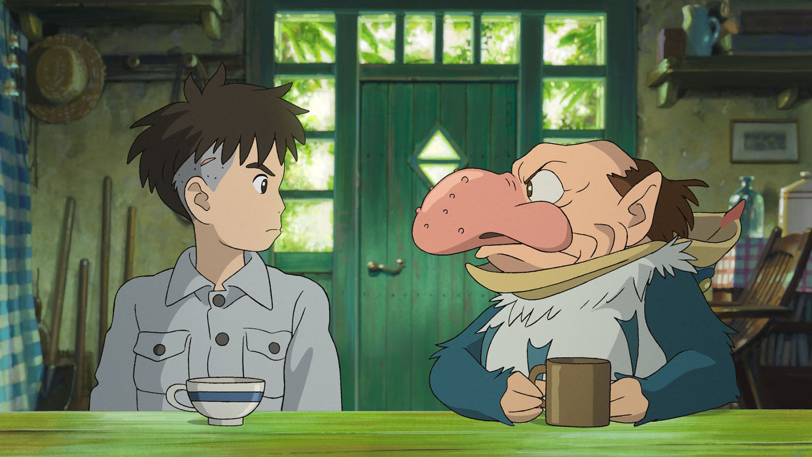 An animated image of a young boy and an older man in a big nose sitting at a table looking at each other with annoyed expressions; the older man clutches a coffee mug, the biy sits with a tea cup.