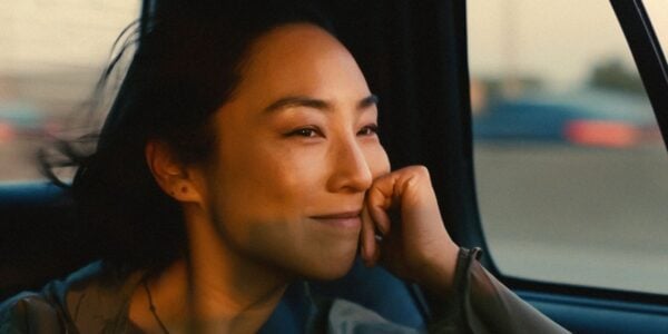 A woman smiles in the back of a car