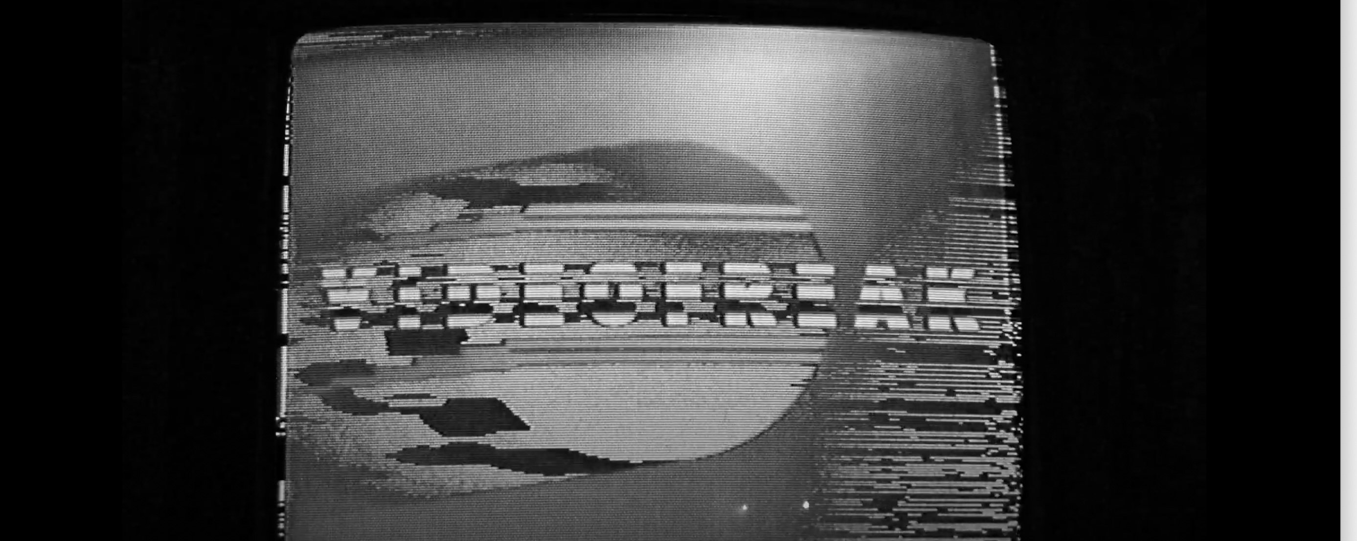 A black and white television screen scrambled by tracking issues, with the words VIDEOFREAK obscured by wavy lines