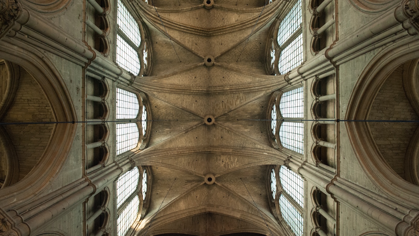 An image of a church's ornate ceiling shot directly from below looking straight up