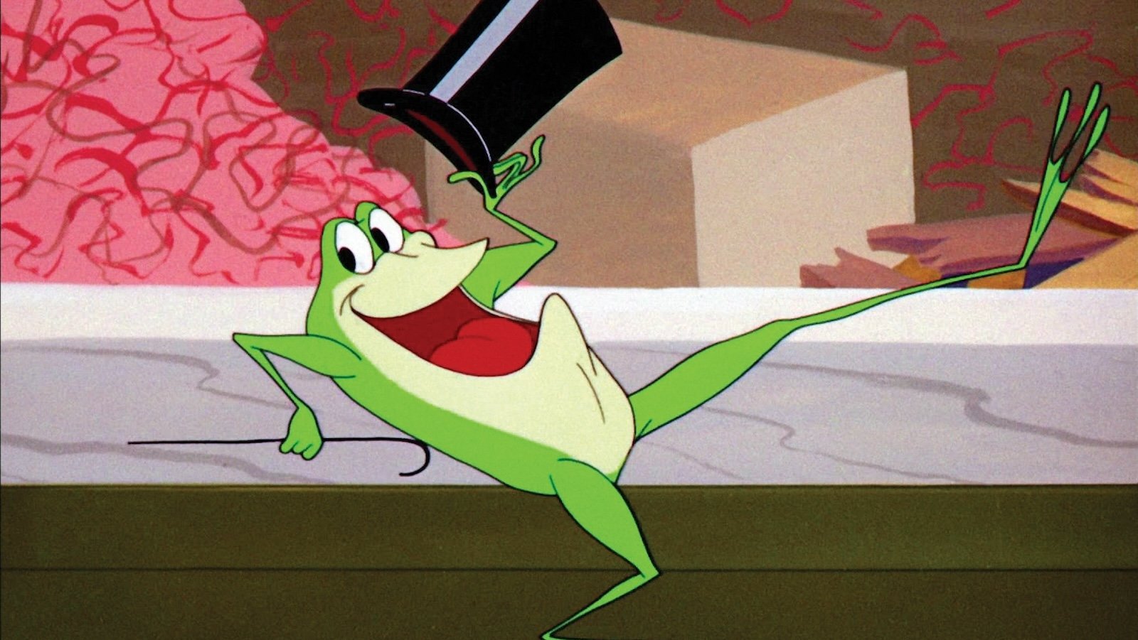 A cartoon frog dancing with a cane and top hat, mouth open smiling at camera.