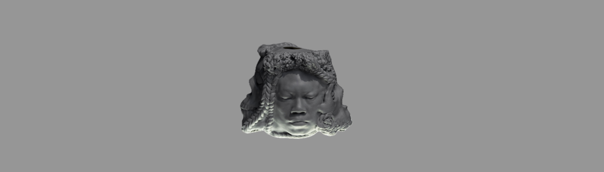 A 3D printed sculpture titled Gray Matter which takes the form of a bust of an African American woman's head with her eyes closed, with a skull protruding from the side of the head.